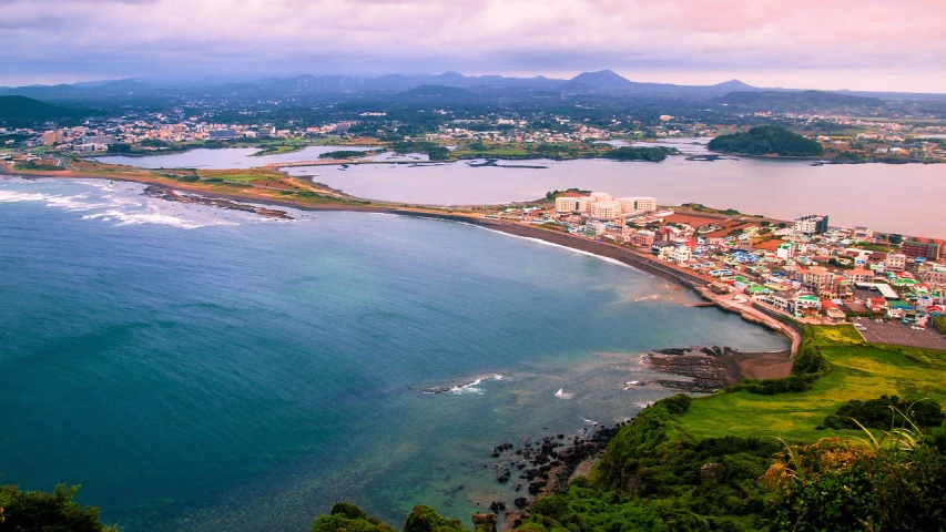 a large body of water surrounded by greenery and a lush green hillside