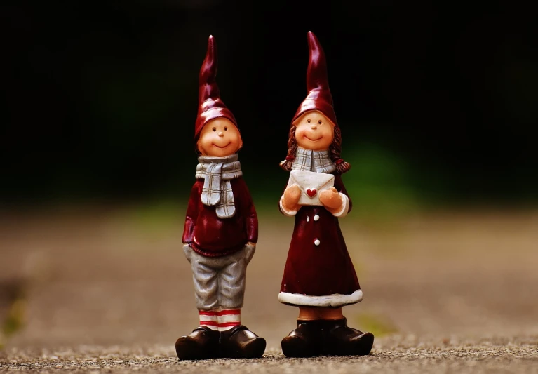 two small figurines that are standing in the road