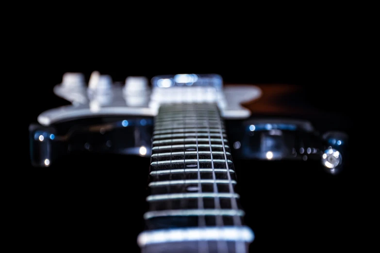 an up close picture of a black and white guitar