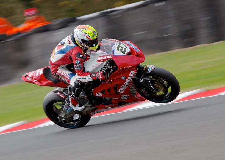 man in red motorcycle racing on a race track