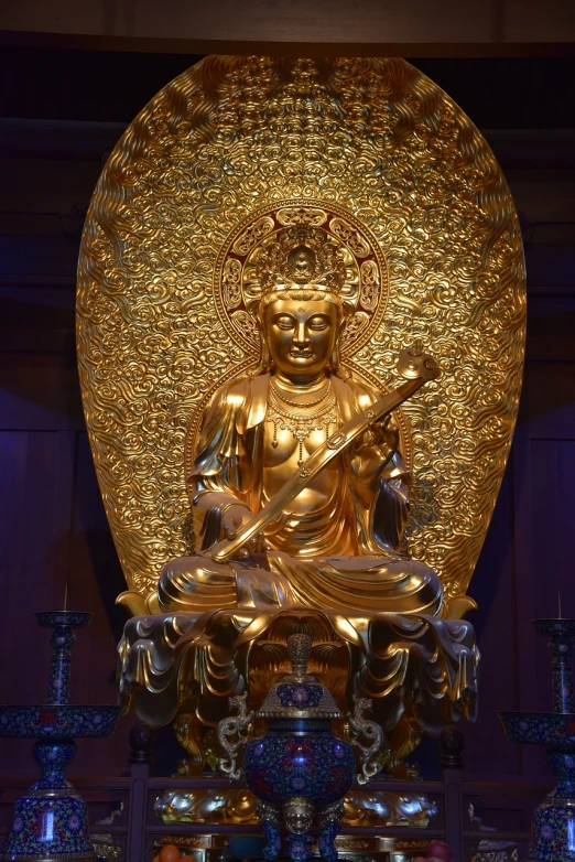 an elaborate golden statue in a room