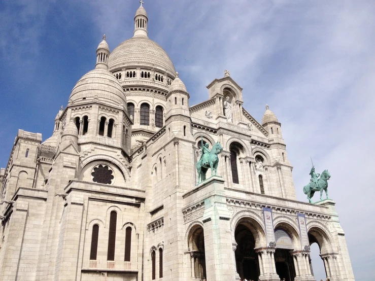 an ornate building with a statue in the center