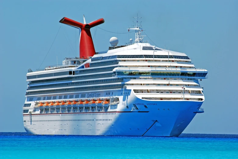 a large white and blue cruise ship in the water