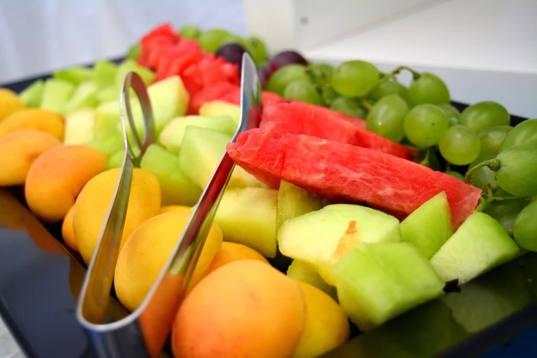 a close up of assorted fruits in a tray