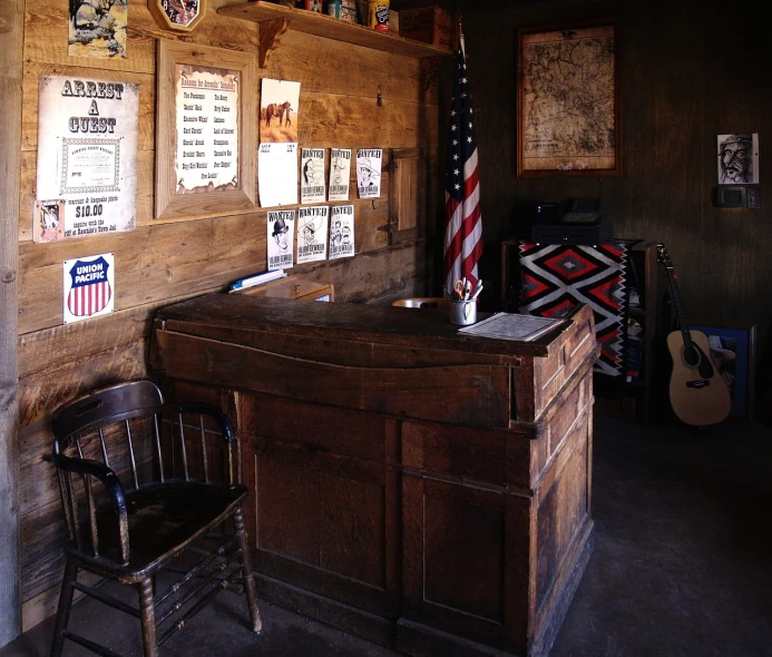 a room with wooden desk and old wall decor