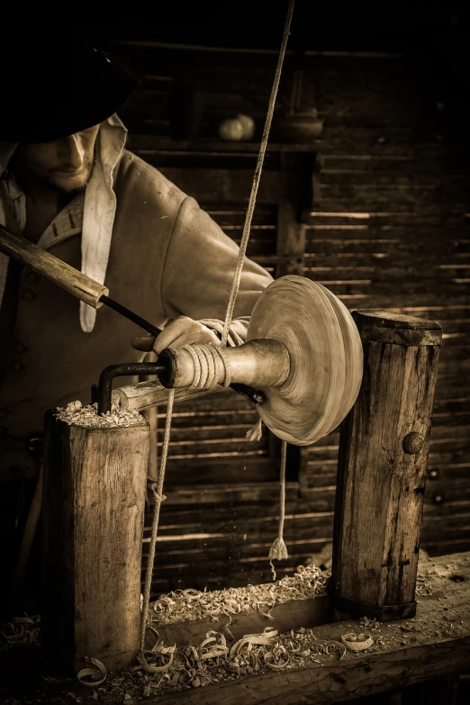 a man working with tools inside of a wooden shed