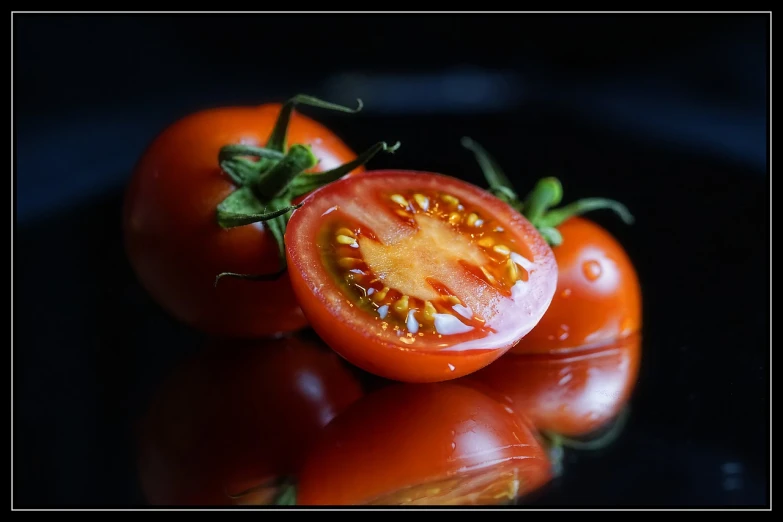 some tomatoes cut in half on a plate