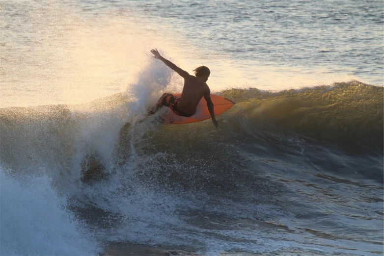 surfer taking very long wave to catch the best wave