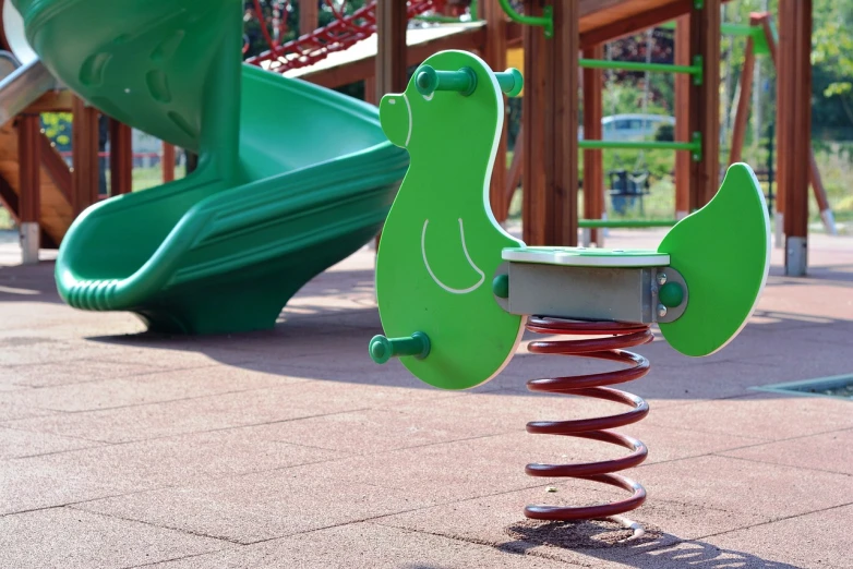 a close up of the swing set with a toddler slide