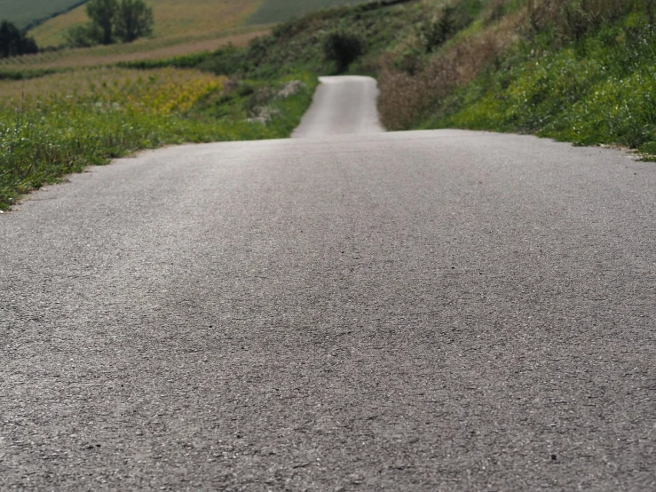 a road with grass growing next to it