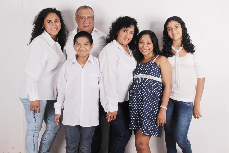 a family in the middle of a group posing for a po