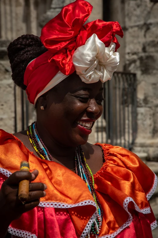 a woman in a red and white dress and a red headdress