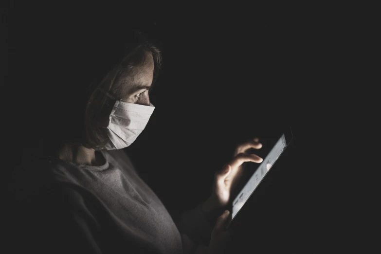 a woman with a face mask and reading a book