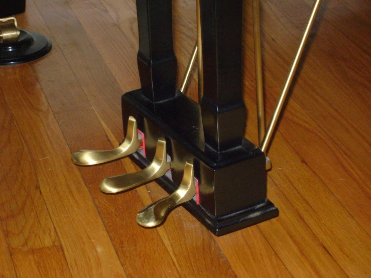 a close up of a clock on a wooden floor