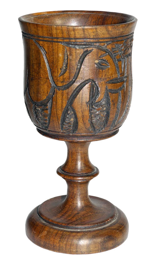 a wooden vase with a bird and flowers pattern