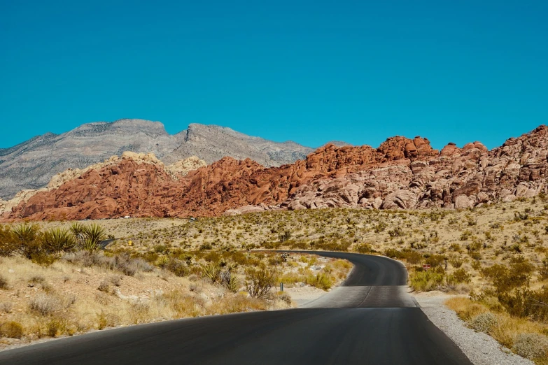 a road with a mountain in the background