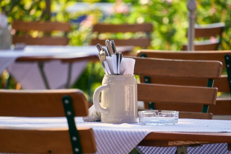 a table with chairs and dishes on top of it