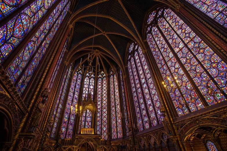 colorfully lit stained glass windows in a gothic cathedral