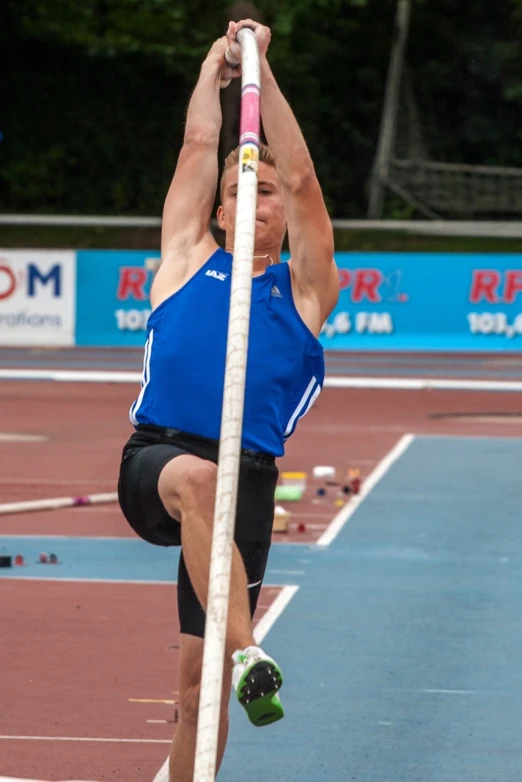 a person doing an exercise on a pole