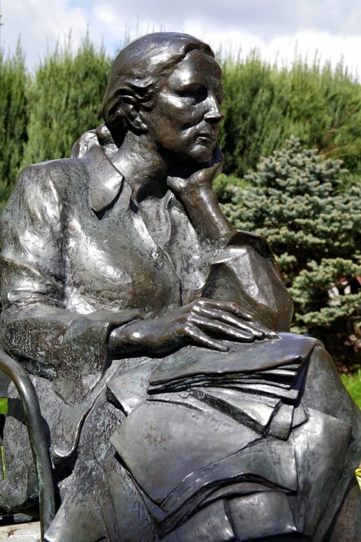 a statue of a person sitting with their feet crossed