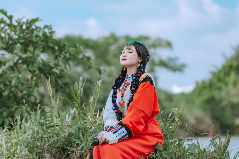 a woman dressed in native indian clothes posing for a pograph