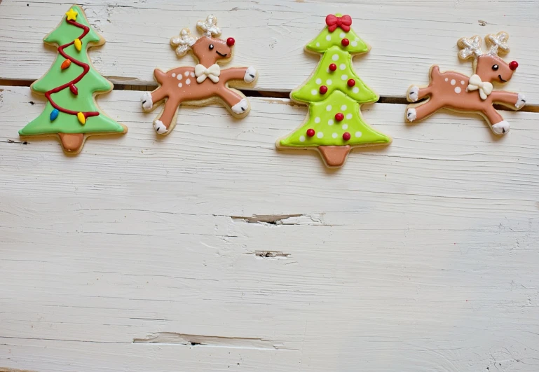 christmas cookies in the shape of trees on a line