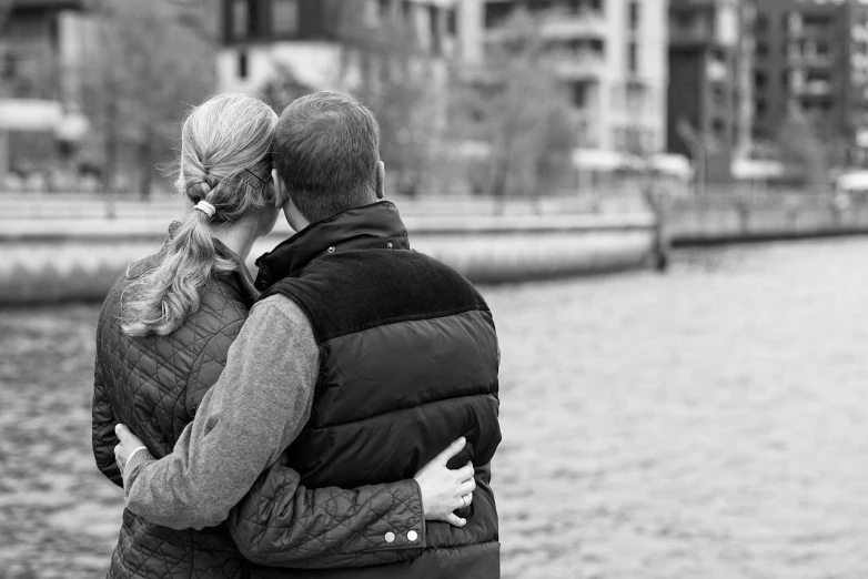 man and woman standing with their backs facing each other