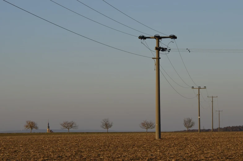 a large field with a lot of power lines above it