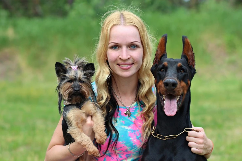 a beautiful woman holding three cute dogs wearing headdress