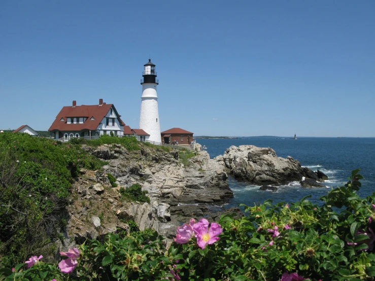 a view of a lighthouse sitting on a rocky outcrop