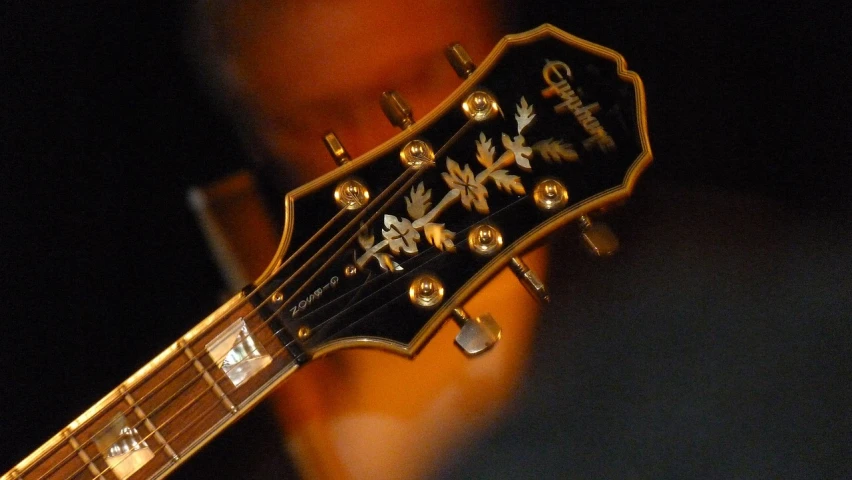 a man with his fingers on an acoustic guitar