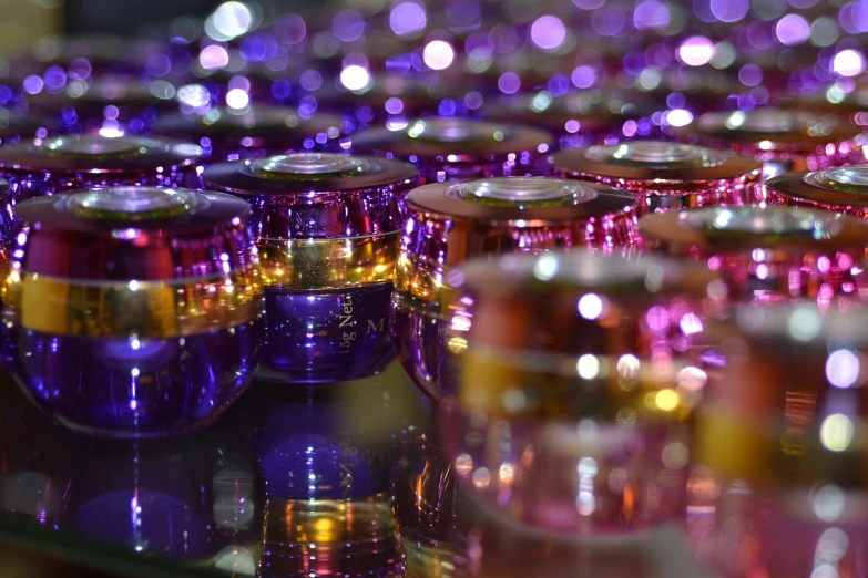 there are many purple and yellow cups sitting on a table