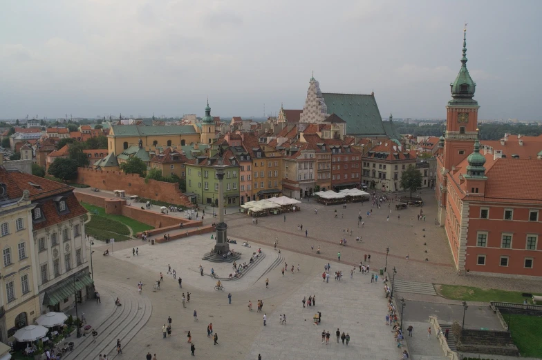 an aerial view of a small plaza with several people walking around