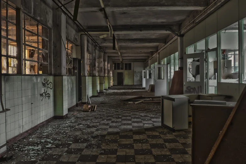 an abandoned building with lots of windows and a tile floor