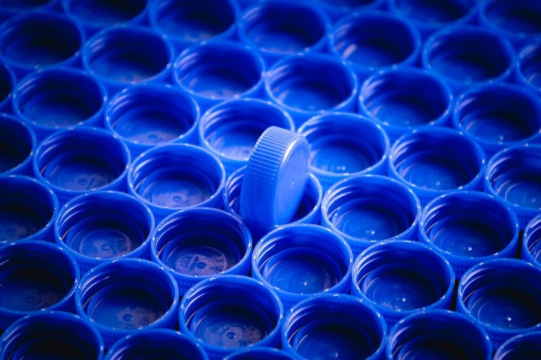 the blue vases are stacked close to one another