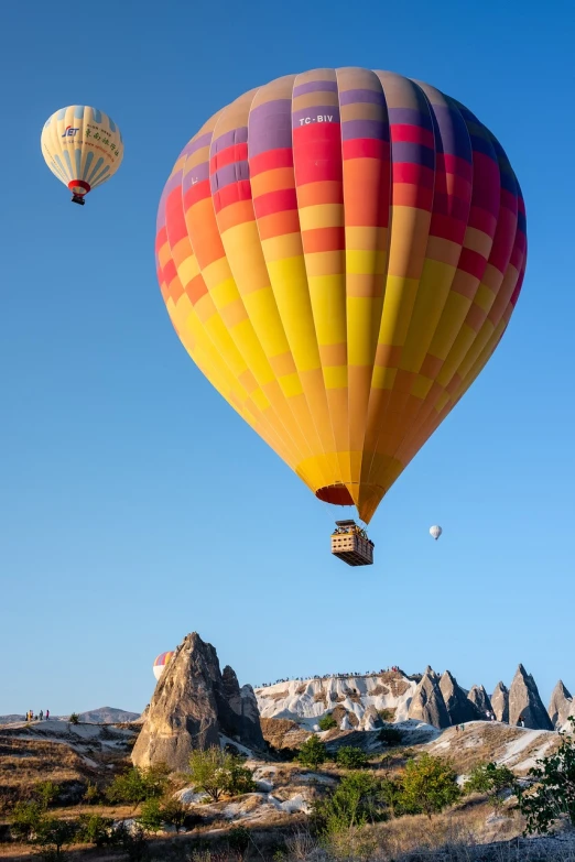 two balloons are flying over the mountains and desert