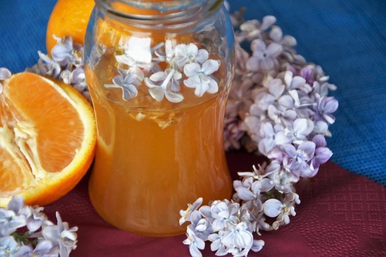 a jar full of honey, lavender and oranges