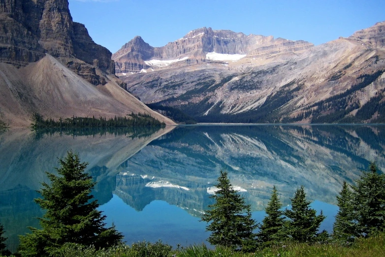 a small pond in front of some mountains