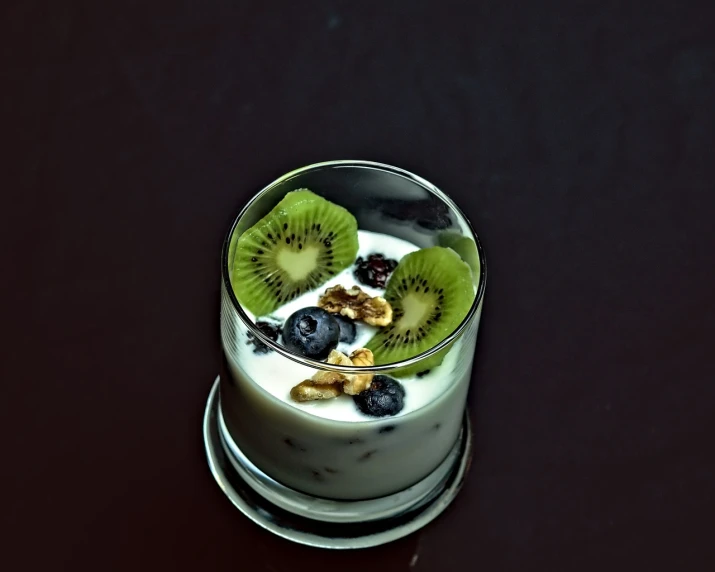 the small bowl has kiwis, blueberries and cereal