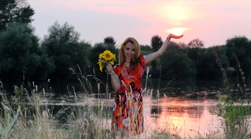 there is a woman wearing a dress holding flowers