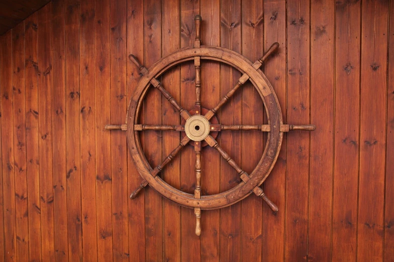 an image of a wooden ship steering wheel