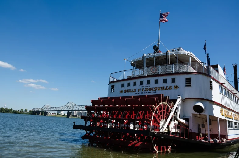 a large red and white boat floating on top of water