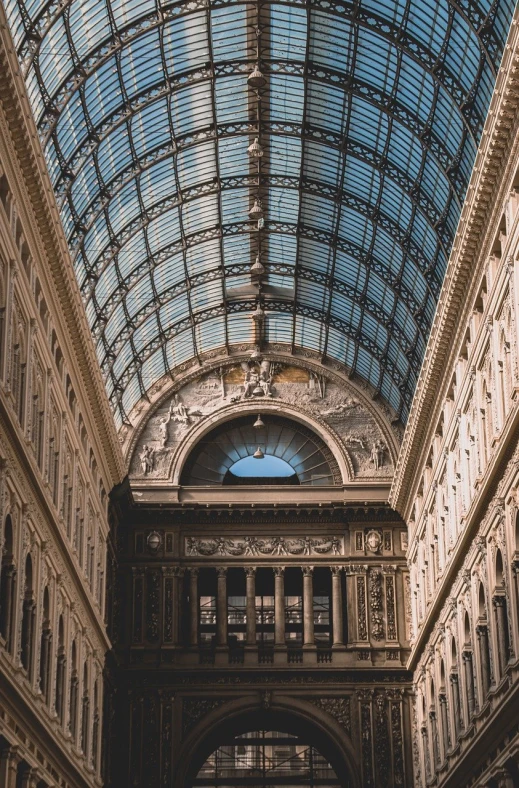 looking up at a large metal and glass building