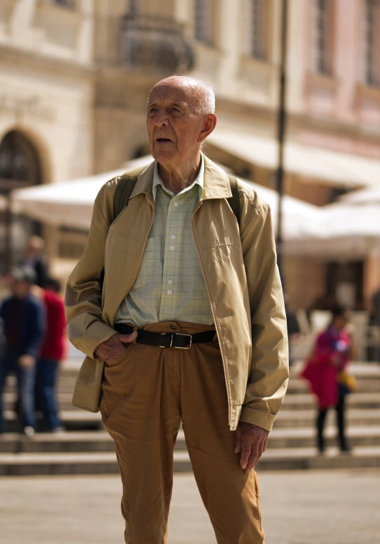 a man in a coat standing on the street