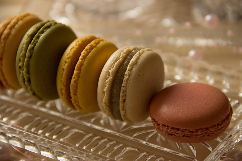 the macarons are on a glass platter