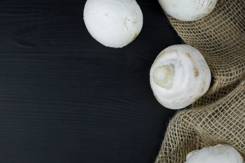 three mushrooms are shown with one being peeled