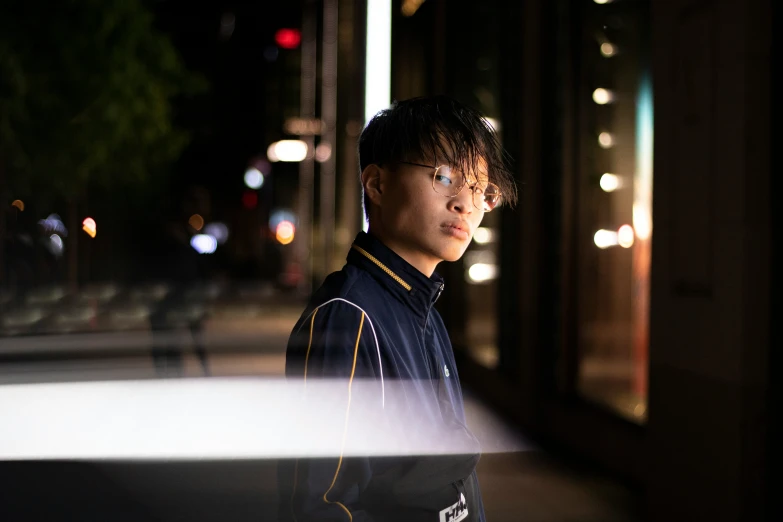 a young man standing in front of a building