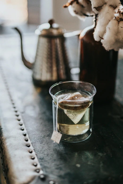 a s of drink with a card in it and some sugar on the side