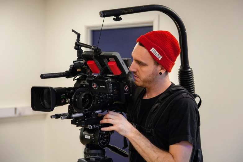 a man standing in front of a camera with his hand on his hips