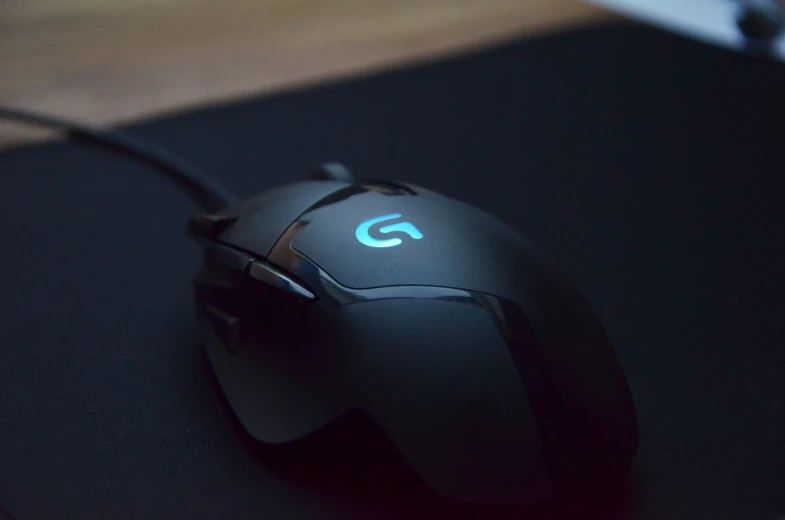 a close up view of a mouse with a circular green logo